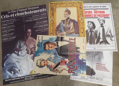 a lot of different movie posters on the floor
