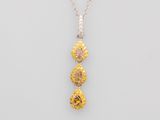 a yellow and white diamond pendant on a silver chain
