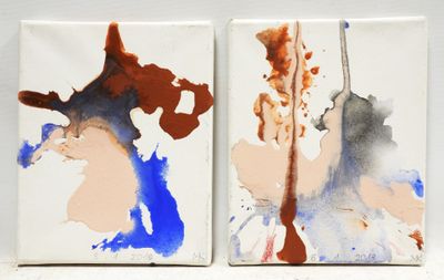 two paintings of different colors and shapes on a white surface