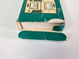 a green book that is open on a white surface
