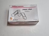 a box of office paper clips sitting on a table