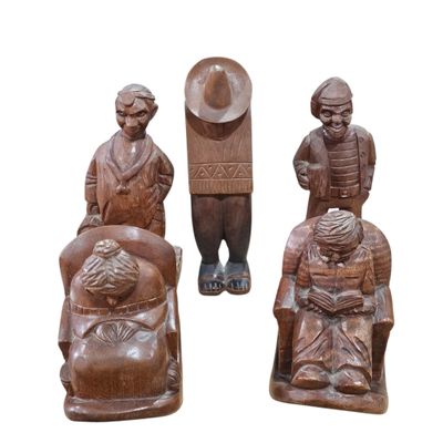 three wooden figurines of people sitting on a bench