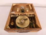 a wooden box with a brass plate inside of it
