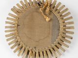 a close up of a sunburst made out of straw and rope