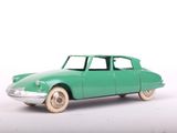 a green toy car that is sitting on a white surface