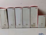 several white boxes of different sizes and colors are lined up on a table