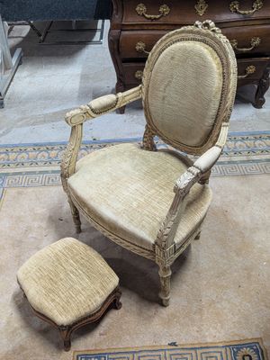 un fauteuil et un pouf dans une pièce où se trouve un tapis