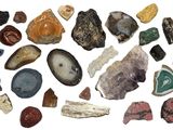 many different types of rocks and stones on this white surface