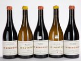 six bouteilles de vin sont alignées sur une surface blanche