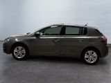 the grey car is parked in a large room with a white wall