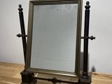 a mirror sitting on a wooden table with a mirror on it