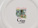 a white plate with a picture of a building on it