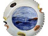 a plate with a picture of a boat in the water