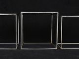 three glass cubes on a black background