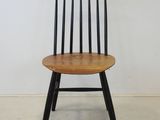 an image of a wooden chair against a white wall