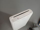 a white nintendo wii game console next to a charger and a charger