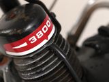 a close up of a motorcycle with a red and white sticker on it
