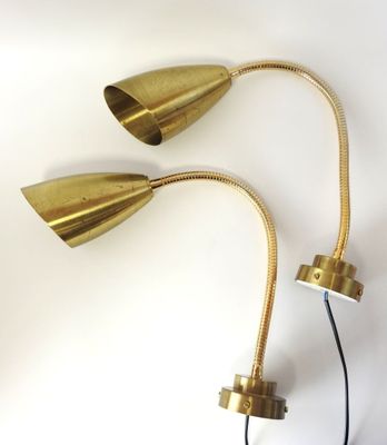 a pair of brass table lamps on a white background