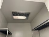 a bathroom with a ceiling fan in the middle of the room