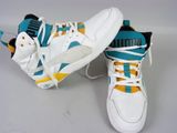 pair of white and blue sneakers with yellow accents on a white surface