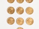 six different types of gold coins arranged in the shape of a heart