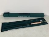 a green pen and pencil set sitting on top of a table