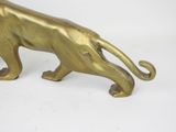 brass figurine of a tiger on a white background