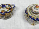 two different types of teapots sitting on a table