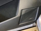 a close up of a car door with a speaker in it