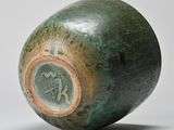 an image of a green vase on a white surface
