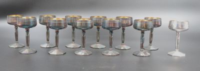 many wine glasses lined up in a row on the table