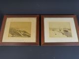 two framed pictures of boats in a harbor on a blue wall