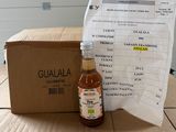 a bottle of liquid sitting next to a box on a table