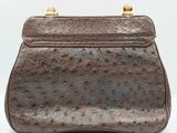 a brown ostrich leather purse with gold hardware
