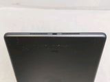 the back of a black laptop computer sitting on top of a table
