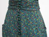 a close up of a woman ' s skirt with buttons on it