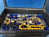 a black box filled with lots of gold and silver jewelry