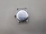 a silver watch that is sitting on a table