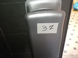 an image of a bathroom with a toilet paper dispenser on the wall