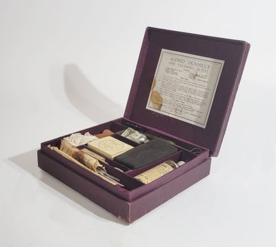 purple box containing a variety of items including a cigarette, a lighter, and a cigarette case