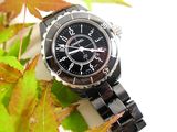a watch that is sitting on a leaf covered surface