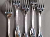 six forks and spoons are arranged in a row on a table