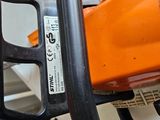 a chainsaw with a chain attached to it ' s handle