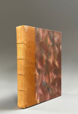 an old book sitting on top of a table next to a white wall
