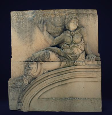 statue of a woman laying on a ledge with a bird on her shoulder