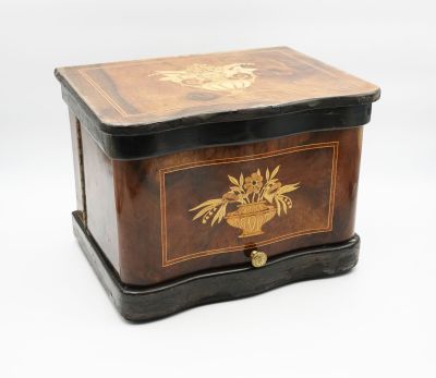 a small wooden box with a bird and flowers on it