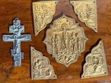 four pieces of metal on a wooden table with a cross and a cross