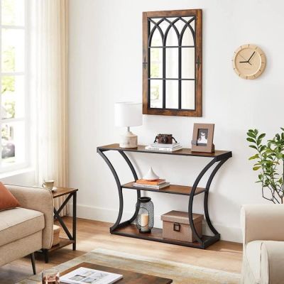a living room with a couch, table, mirror and a clock on the wall