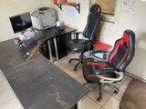 a desk with two chairs and a computer on it