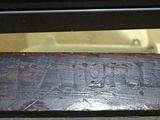 a close up of a wooden bench with a sign on it